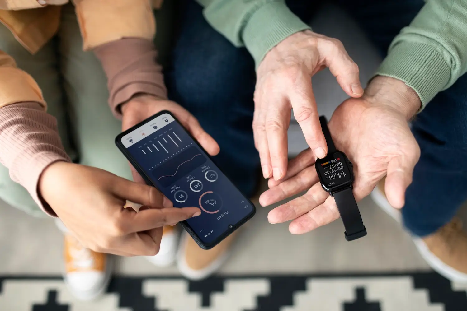 arabic-woman-teaching-senior-man-use-smartwatch-with-smartphone