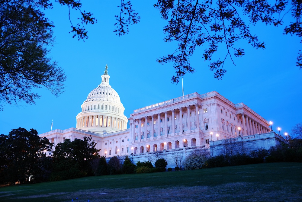 Capitol Hill Building at dusk with light and blue sky, Washington DC.
