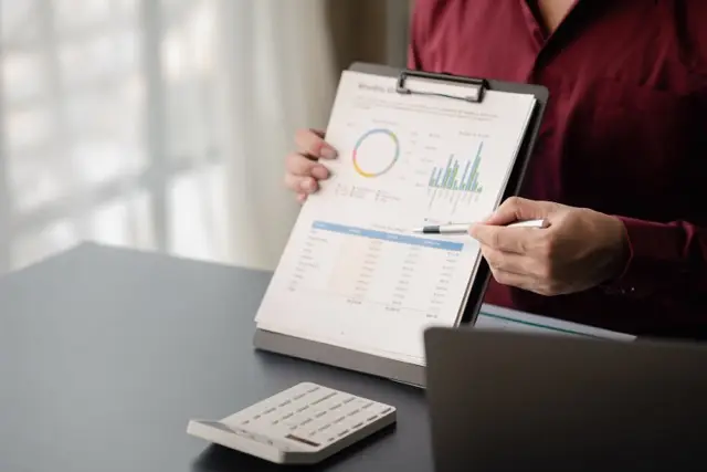 business-man-pointing-to-a-pie-chart-document