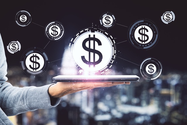 hand-holding-tablet-with-abstract-glowing-dollars