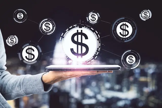 hand-holding-tablet-with-abstract-glowing-dollars